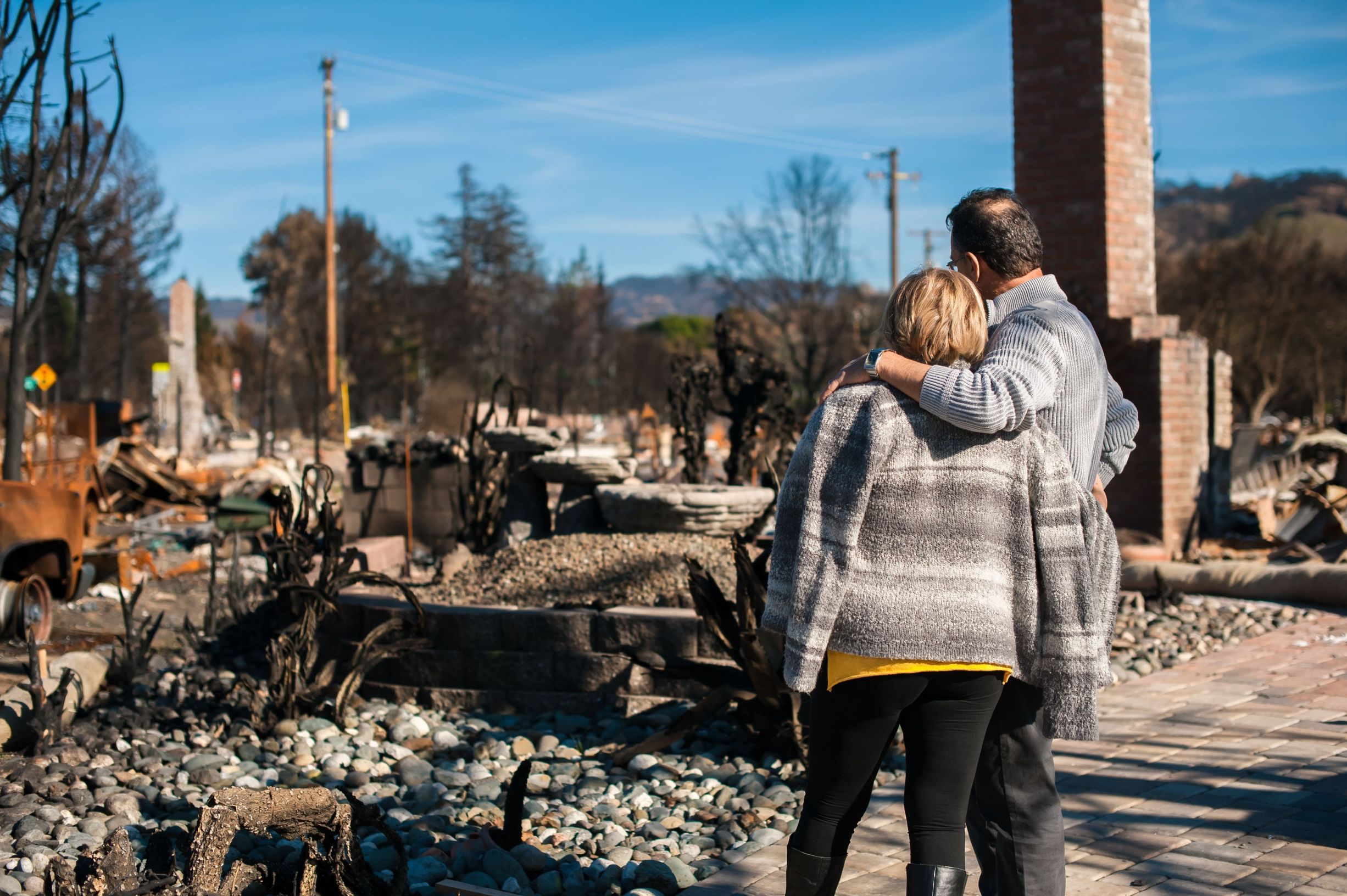 Man and his wife owners, checking burned and ruined house